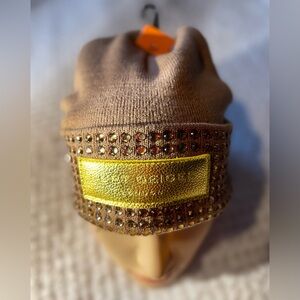 Stylish Camel Beanie with Gold Accents by Kurt Geiger.
NWOT